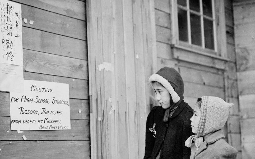 Japanese-Canadian girls reading signs outside the school